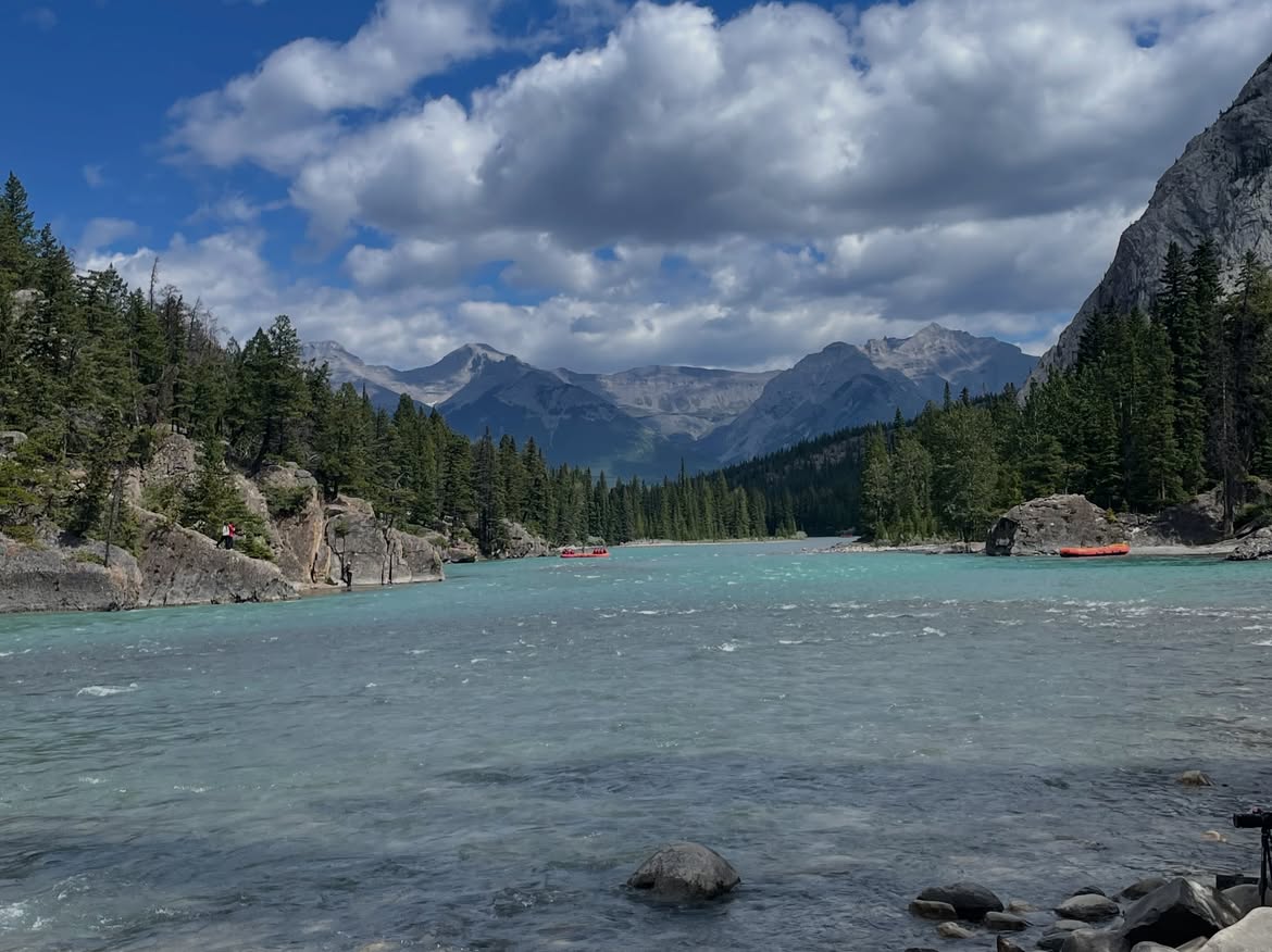 The Bow River near Bow Falls with rafts and mountains in the background
